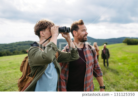 Father showig somenting in distance to son during hiking trip. Father showig somenting in distance to son during hiking trip. 131125350