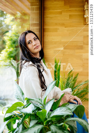 Portrait of smiling woman enjoying a peaceful moment at home Portrait of smiling woman enjoying a peaceful moment at home 131125439