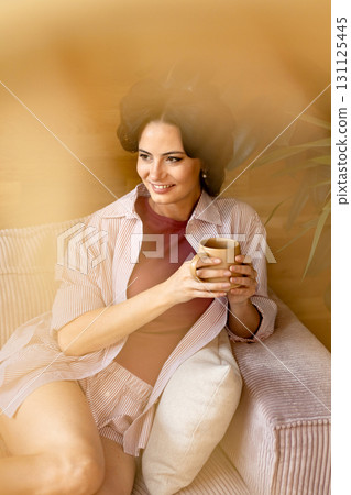 Portrait of woman with hair rollers during slow morning. Portrait of woman with hair rollers during slow morning. 131125445