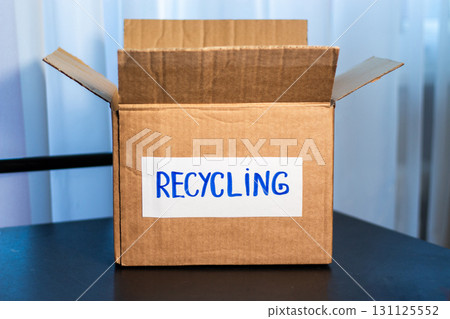 Box of used clothing marked for recycling. Eco friendly lifestyle. Closet management. 131125552