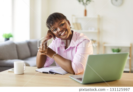 Portrait Of Smiling African American Woman Working On Laptop At Home Office 131125997