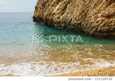 Top view of beautiful blue sea water with sand beach among mountains and rocks. 131126728
