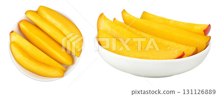 mango slices in ceramic bowl isolated on white background. Top view. Flat lay mango slices in ceramic bowl isolated on white background. Top view. Flat lay 131126889