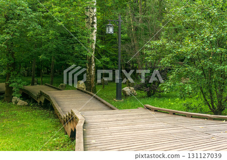 Wooden walkway in the park in summer Wooden walkway in the park in summer 131127039