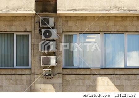 Air conditioners on the facade of the house, ventilation and cooling system. Air conditioners on the facade of the house, ventilation and cooling system. 131127158