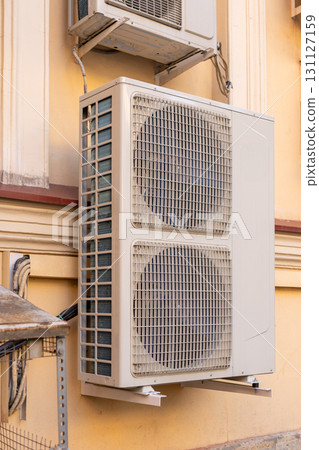 industrial C air conditioner is installed on the facade of a house or office. 131127159
