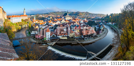 Panoramic view of Cesky Krumlov, showcasing the UNESCO-listed historic center surrounded by the Vltava River in a meander. A sunny autumn day highlights the town's charm. Panoramic view of Cesky Krumlov, showcasing the UNESCO-listed historic center surrounded by the Vltava River in a meander. A sunny autumn day highlights the town's charm. 131127198