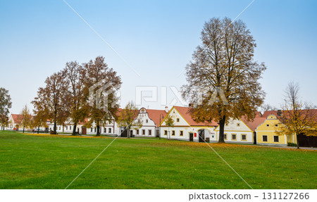 Medieval houses, farms, and granaries of Holasovice village in South Bohemia, arranged around a park with ponds. A UNESCO World Heritage Site showcasing rural baroque architecture Medieval houses, farms, and granaries of Holasovice village in South Bohemia, arranged around a park with ponds. A UNESCO World Heritage Site showcasing rural baroque architecture 131127266