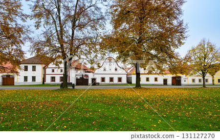 Medieval houses, farms, and granaries of Holasovice village in South Bohemia, arranged around a park with ponds. A UNESCO World Heritage Site showcasing rural baroque architecture 131127270
