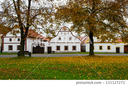 Medieval houses, farms, and granaries of Holasovice village in South Bohemia, arranged around a park with ponds. A UNESCO World Heritage Site showcasing rural baroque architecture Medieval houses, farms, and granaries of Holasovice village in South Bohemia, arranged around a park with ponds. A UNESCO World Heritage Site showcasing rural baroque architecture 131127271