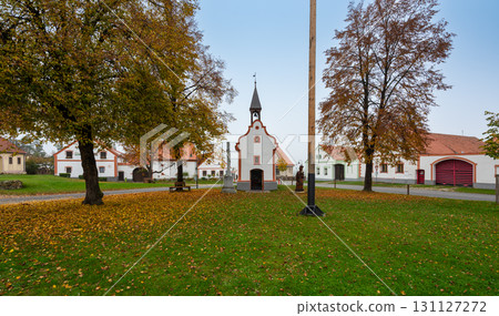 Medieval houses, farms, and granaries of Holasovice village in South Bohemia, arranged around a park with ponds. A UNESCO World Heritage Site showcasing rural baroque architecture Medieval houses, farms, and granaries of Holasovice village in South Bohemia, arranged around a park with ponds. A UNESCO World Heritage Site showcasing rural baroque architecture 131127272