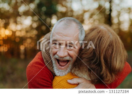 Portrait of senior man hugging his wife in autumn nature. Portrait of senior man hugging his wife in autumn nature. 131127284