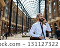 Handsome businessman with smartphone in the city, making a phone call. 131127322