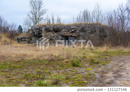 A historical image of a well-preserved infantry bunker near the town of Kraliky, showcasing its solid concrete structure and significance as a part of Czechoslovakia's wartime fortifications. A historical image of a well-preserved infantry bunker near the town of Kraliky, showcasing its solid concrete structure and significance as a part of Czechoslovakia's wartime fortifications. 131127346
