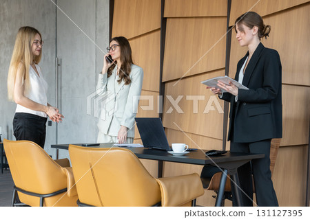 Three women conducting informal mentoring in a shared office Three women conducting informal mentoring in a shared office 131127395