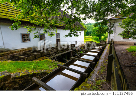 The mill in Babiccino Valley is a historic structure set amidst lush nature, representing the rural heritage and charm of Bozena Nemcova's "Babicka," with its tranquil surroundings and scenic beauty. 131127496
