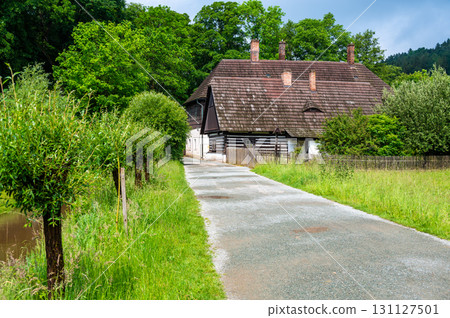 The Old Grandmother's House in Babiccino Valley is a charming historical cottage surrounded by lush greenery, blooming meadows, and the serene Upa River, embodying the essence of Bozena Nemcova's 131127501