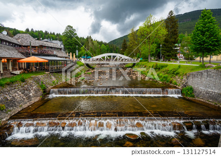 Famous white bridge over Elbe river at Spindleruv Mlyn city, Czech Republic. Famous tourist destination. 131127514
