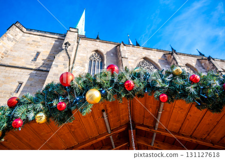 A festive scene with Christmas decorations in the foreground and the Cathedral of St. Bartholomew in Plzen, Czech Republic, in the background. A charming mix of tradition and holiday spirit 131127618