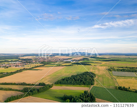 A stunning drone view of Hrusovany u Brna, showcasing the charming town, surrounding vineyards, and a distant, scenic view of the Palava Hills. 131127639