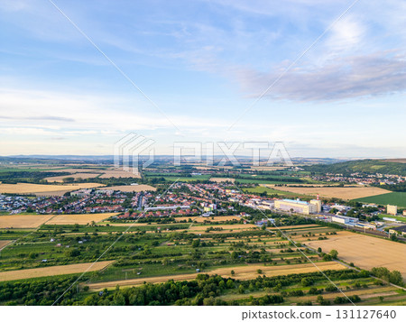 A stunning drone view of Hrusovany u Brna, showcasing the charming town, surrounding vineyards, and a distant, scenic view of the Palava Hills. 131127640