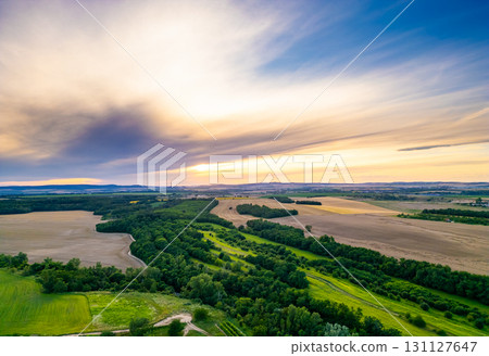 A stunning drone view of Hrusovany u Brna, showcasing the charming town, surrounding vineyards, and a distant, scenic view of the Palava Hills. A stunning drone view of Hrusovany u Brna, showcasing the charming town, surrounding vineyards, and a distant, scenic view of the Palava Hills. 131127647