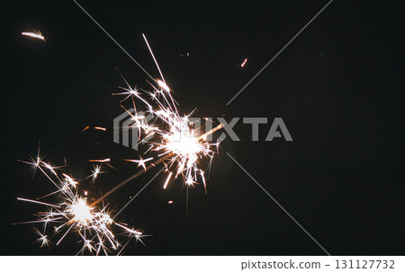 sparkler in the dark, festive glow 131127732
