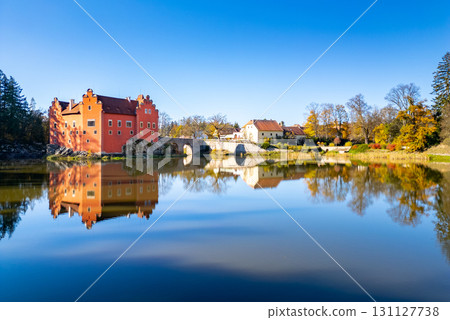 A panoramic drone photo of Cervena Lhota Castle (Red Chateau, Schloss Rot), showing the castle reflection in the pond below. A panoramic drone photo of Cervena Lhota Castle (Red Chateau, Schloss Rot), showing the castle reflection in the pond below. 131127738