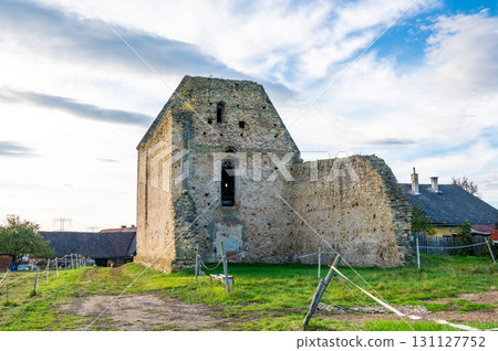 A photo of the ruins of the Koruna Svate Marie Monastery near the village of Trebarov. The ancient stone walls and arches stand as a testament to history, surrounded by greenery. This historic site 131127752