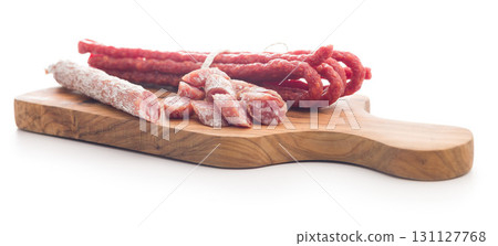 Sliced fuet sausage with mold isolated on white background. Sliced fuet sausage with mold isolated on white background. 131127768