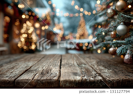 A wooden table with a Christmas tree decorated with silver balls. Empty wooden space against a Christmas background. 131127794