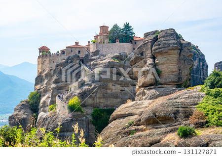 Monastery Meteora Greece. Stunning summer panoramic landscape. View at mountains and green forest against epic blue sky with clouds. UNESCO heritage list object. Monastery Meteora Greece. Stunning summer panoramic landscape. View at mountains and green forest against epic blue sky with clouds. UNESCO heritage list object. 131127871