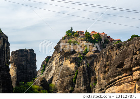 Monastery Meteora Greece. Stunning summer panoramic landscape. View at mountains and green forest against epic blue sky with clouds. UNESCO heritage list object. Monastery Meteora Greece. Stunning summer panoramic landscape. View at mountains and green forest against epic blue sky with clouds. UNESCO heritage list object. 131127873