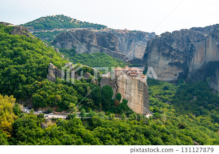 Monastery Meteora Greece. Stunning summer panoramic landscape. View at mountains and green forest against epic blue sky with clouds. UNESCO heritage list object. Monastery Meteora Greece. Stunning summer panoramic landscape. View at mountains and green forest against epic blue sky with clouds. UNESCO heritage list object. 131127879