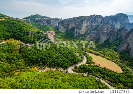 Monastery Meteora Greece. Stunning summer panoramic landscape. View at mountains and green forest against epic blue sky with clouds. UNESCO heritage list object. Monastery Meteora Greece. Stunning summer panoramic landscape. View at mountains and green forest against epic blue sky with clouds. UNESCO heritage list object. 131127881