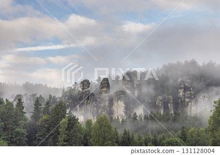 Adrspach-Teplice Rocks, sandstone formations in Hradec Kralove Region in the Czech Republic, Europe. Mystical landscape featuring unusual rock formations emerging through a dense, low-lying fog. 131128004