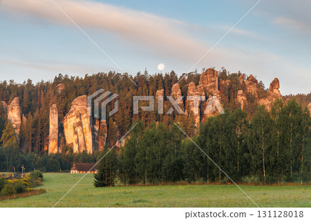 Adrspach-Teplice Rocks, sandstone formations in Hradec Kralove Region in the Czech Republic, Europe. Majestic rock formations stand tall against a backdrop of lush forest, under soft glow of the moon. Adrspach-Teplice Rocks, sandstone formations in Hradec Kralove Region in the Czech Republic, Europe. Majestic rock formations stand tall against a backdrop of lush forest, under soft glow of the moon. 131128018