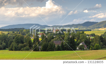 The Broumovsko Protected Landscape Area in Hradec Kralove Region in the Czech Republic, Europe. Scenic countryside vista featuring a village nestled among lush greenery. The Broumovsko Protected Landscape Area in Hradec Kralove Region in the Czech Republic, Europe. Scenic countryside vista featuring a village nestled among lush greenery. 131128035