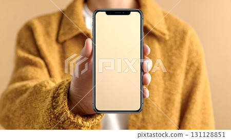 Woman holding smartphone with blank screen showing mobile app design 131128851