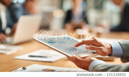 Hands operating a tablet at a business meeting 131128932