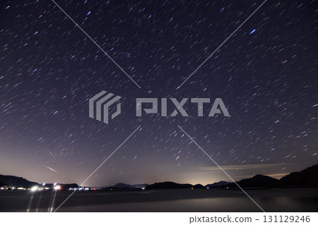 Winter starry sky over the Setouchi Inland Sea: Star trails and Starlink satellite tracks Winter starry sky over the Setouchi Inland Sea: Star trails and Starlink satellite tracks 131129246