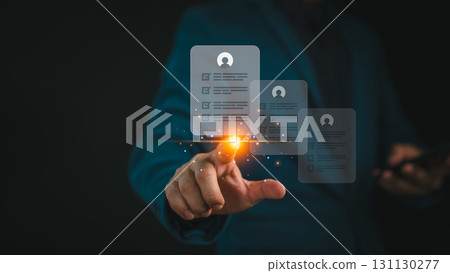 Businessman touching a digital candidate profile interface, selecting employee for recruitment. Concept of digital HR technology, job screening, resume evaluation, and human resources management. Businessman touching a digital candidate profile interface, selecting employee for recruitment. Concept of digital HR technology, job screening, resume evaluation, and human resources management. 131130277