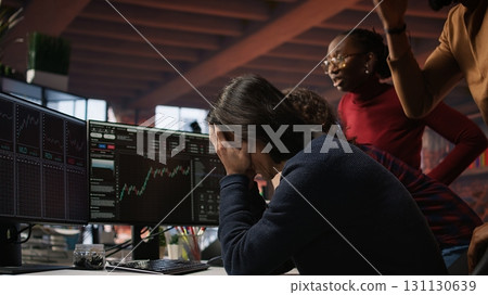 Startup team concerned by company stock valuation dropping, signaling future funding challenges. Venture management distraught by financial decline leading to budget cuts and layoffs, camera A 131130639