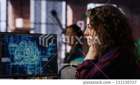 Startup employee shocked after successfully launching on stock market, generating high investment returns. Tech venture manager surprised after securing funding for pioneering software, camera B 131130727