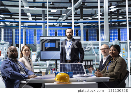 Portrait of industrial factory executives doing meeting to discuss solar panel automation strategies. Production plant leadership team colleagues gathered together to enhance manufacturing processes 131130838