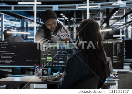 Data center manager supervising engineer setting up machine learning systems handling information. Supervisor oversees worker training node trees neural networks to improve server hub operations Data center manager supervising engineer setting up machine learning systems handling information. Supervisor oversees worker training node trees neural networks to improve server hub operations 131131107