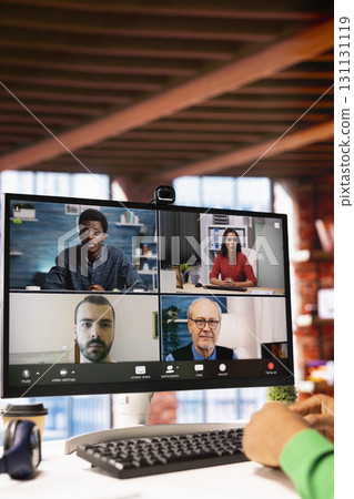 Remote worker looking at PC monitor discussing with coworkers during videocall from home. Close up of computer display used by teleworker in remote teleconference meeting with colleagues 131131119