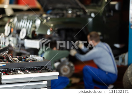 Workshop for car repair with table with different tools in garage 131132171