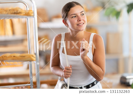 Young woman looking around in bakery Young woman looking around in bakery 131132263