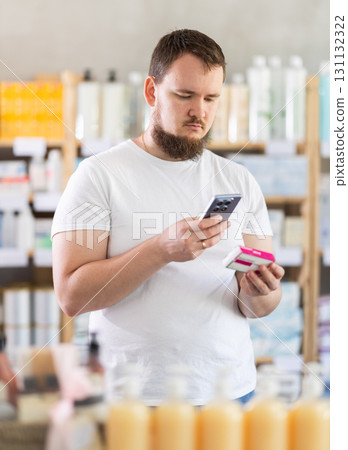 Young man scanning qr code of paracetamol 131132322